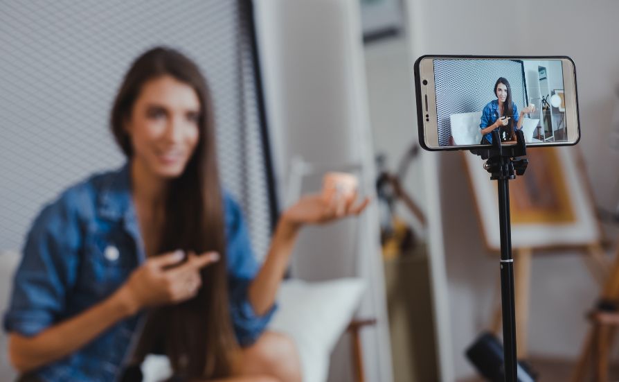 Photo of a woman showing off her product in a photo on her phone